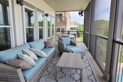 Covered and screened outside deck with room for couch, chairs, and table with seating.