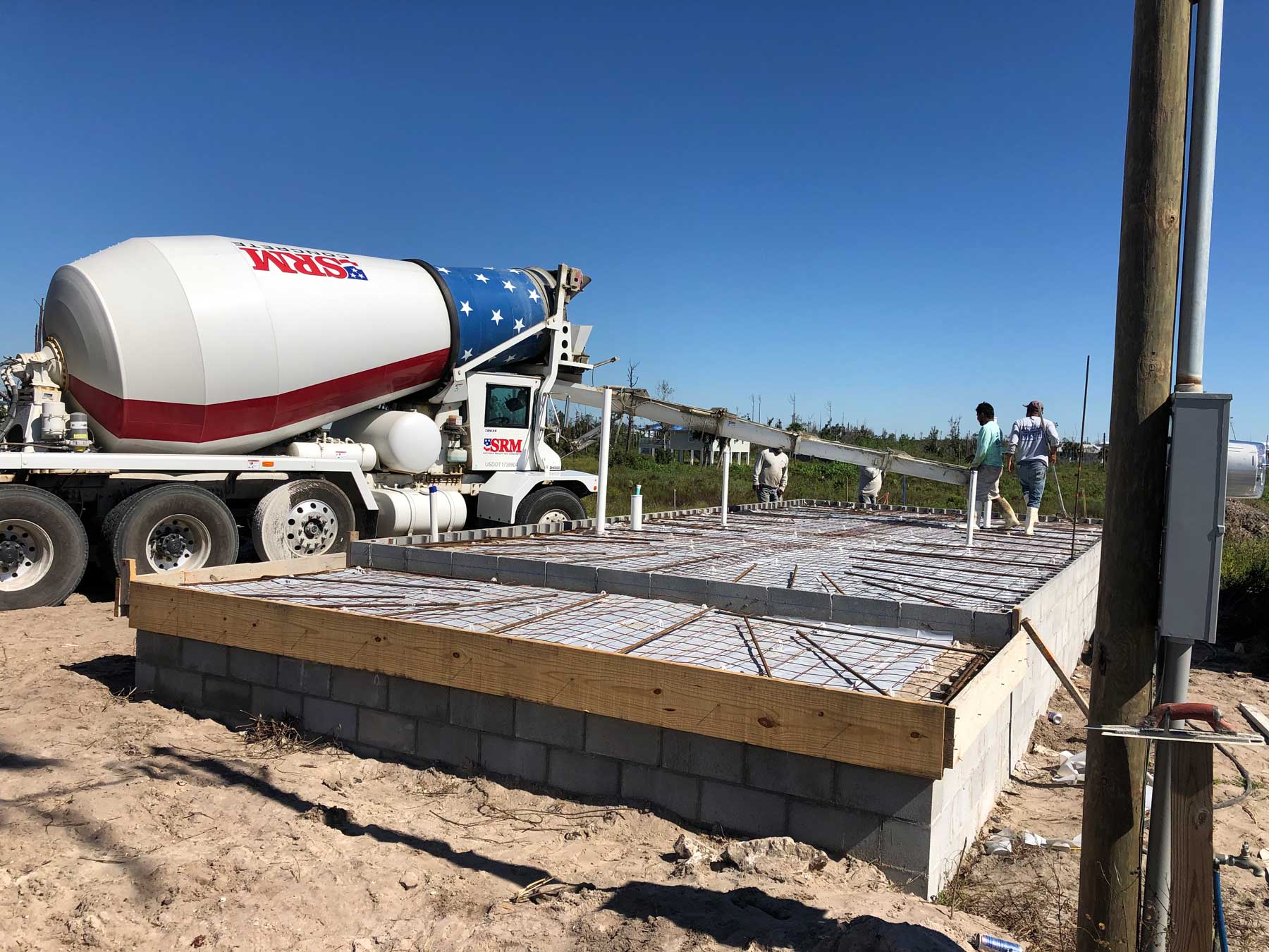 A cement truck pours the foundation of this new Mexico Beach home under construction.