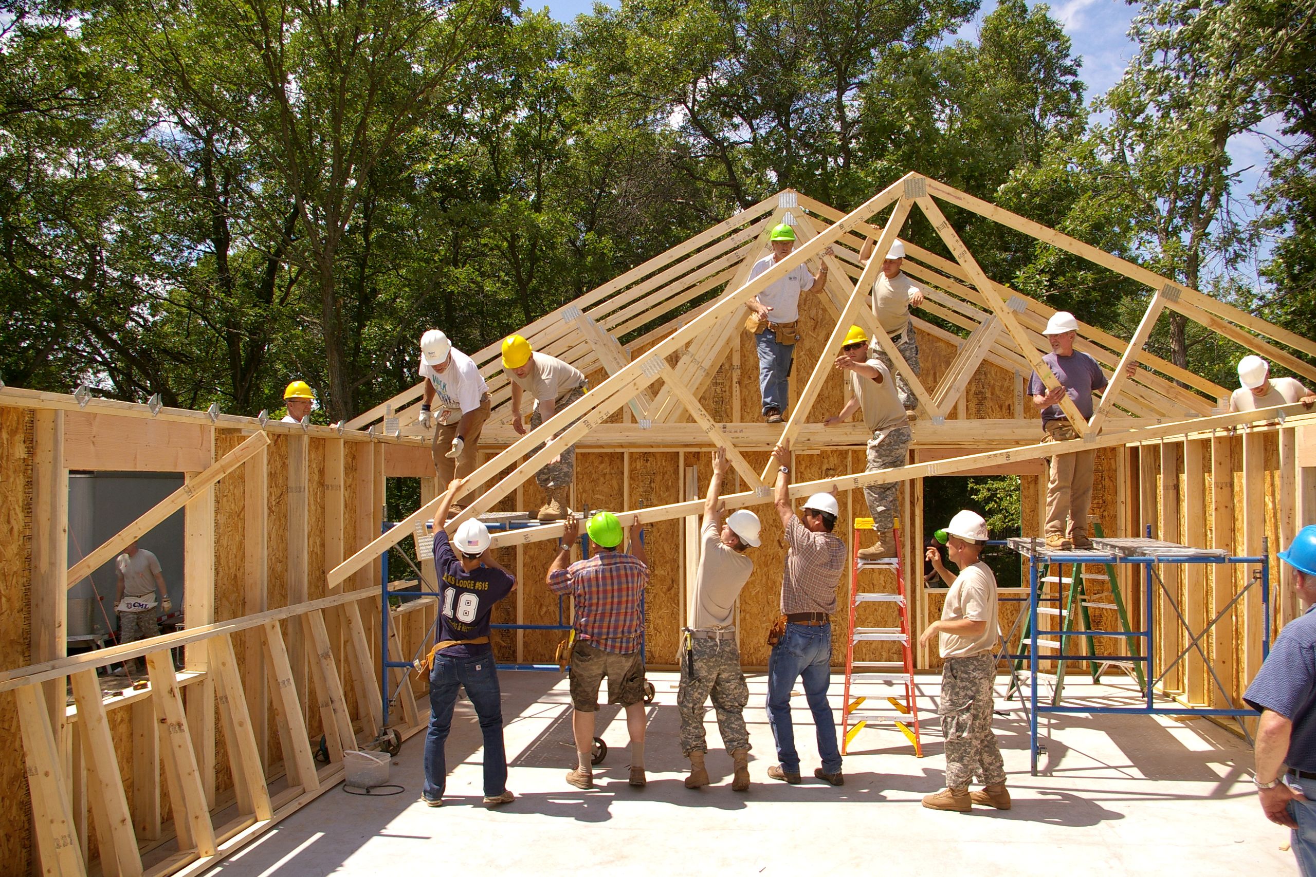 Workers building a new house with hurricane straps