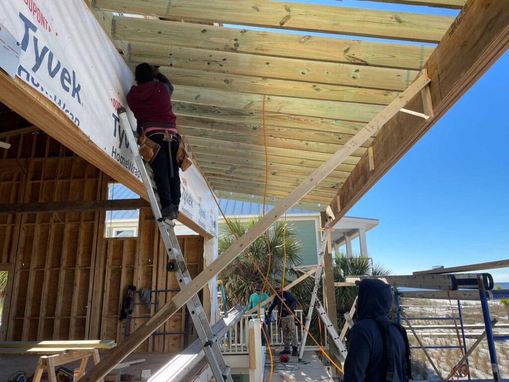 Worker fixing deck overhand.