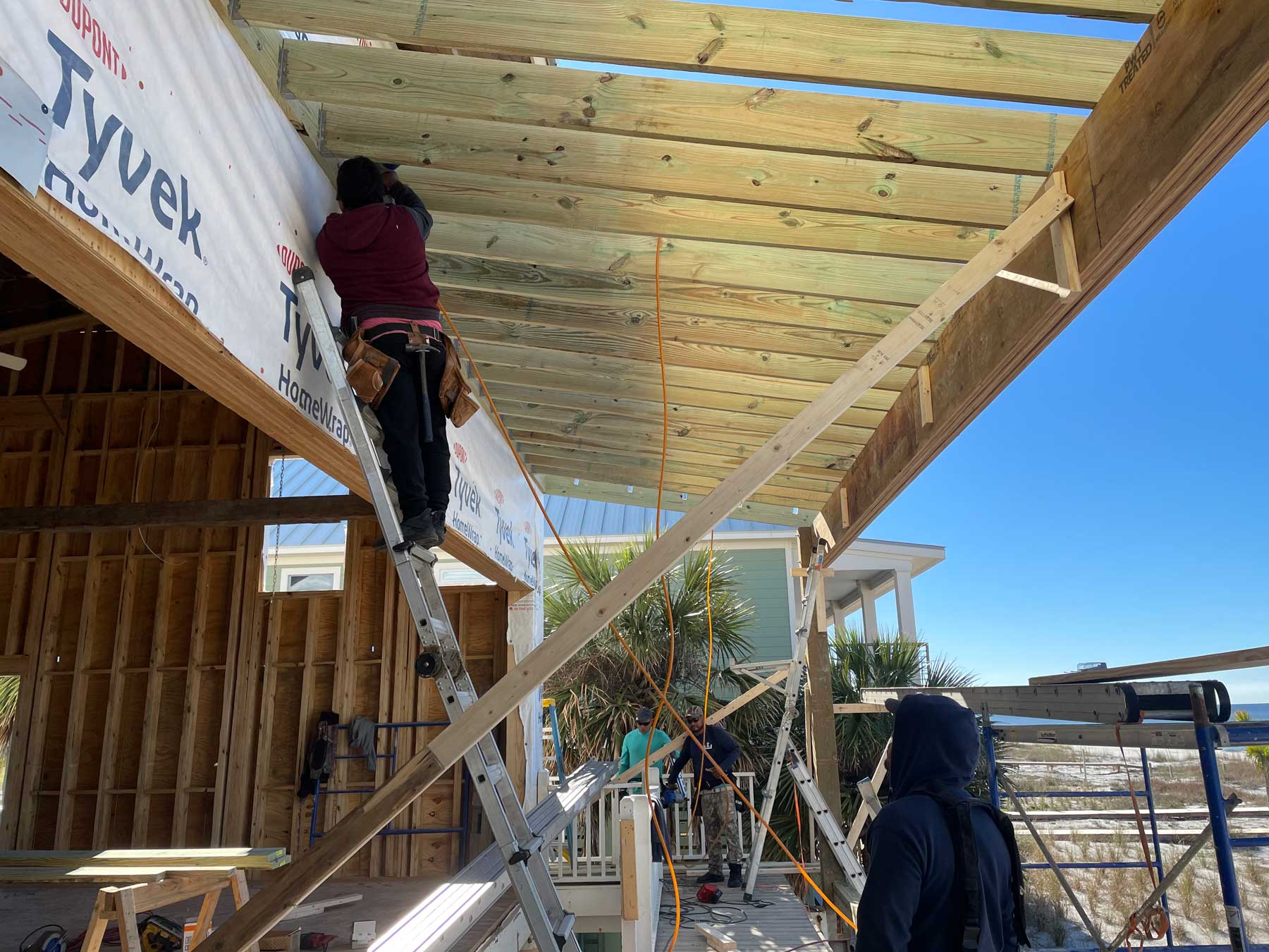 Worker repairing deck from hurricane damage.